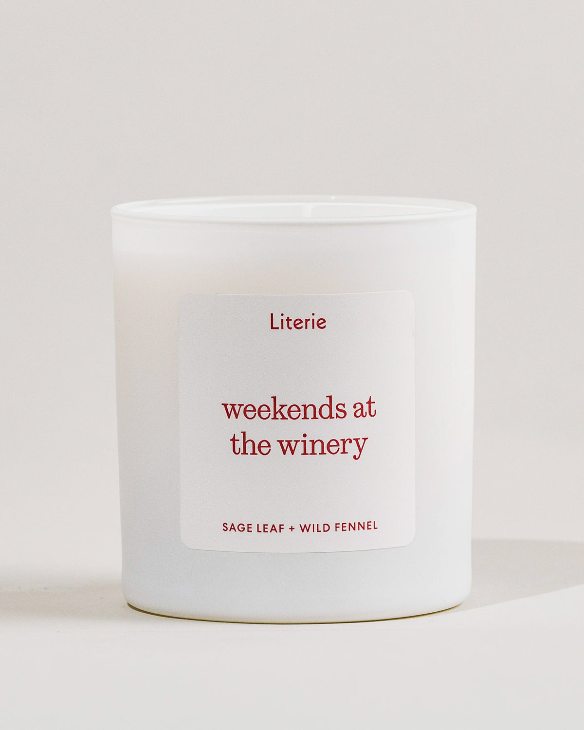 White Literie candle with a 'weekends at the winery' label on a light gray background
