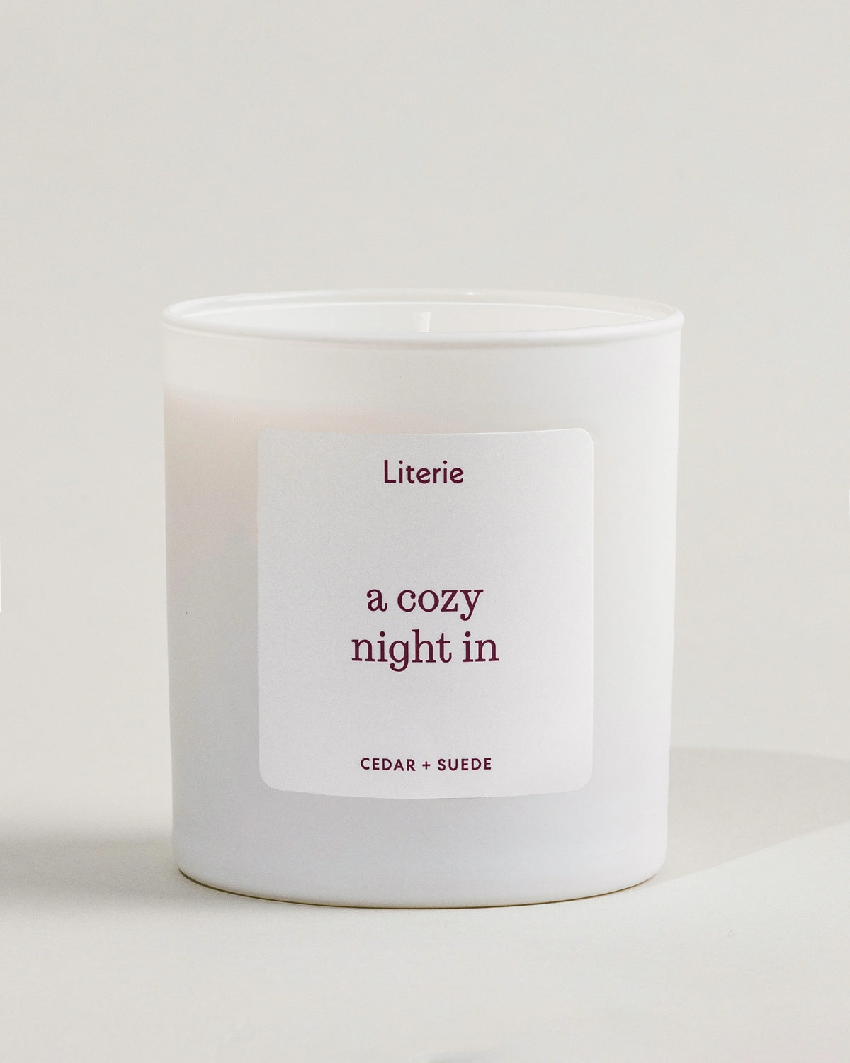 'a cozy night in' candle by Literie on a neutral background.