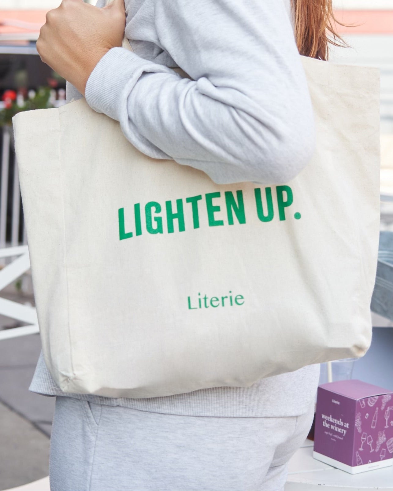 lighten up tote bag with candle.