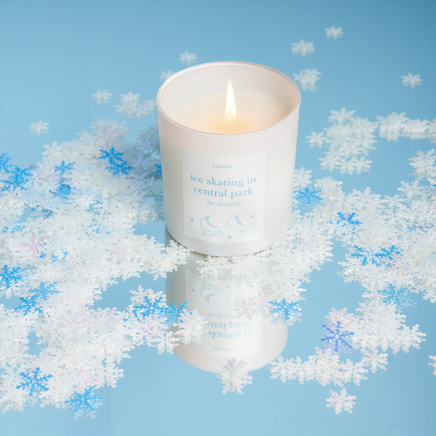 ice skating in central park candle with snowflakes.