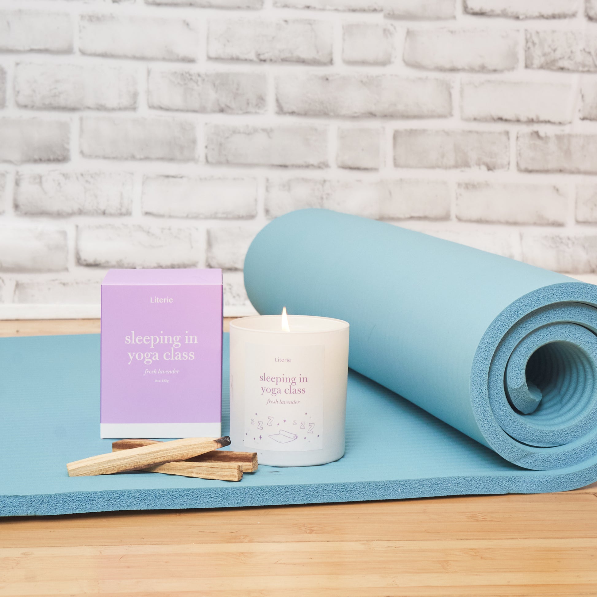 sleeping in yoga class candle on yoga mat.