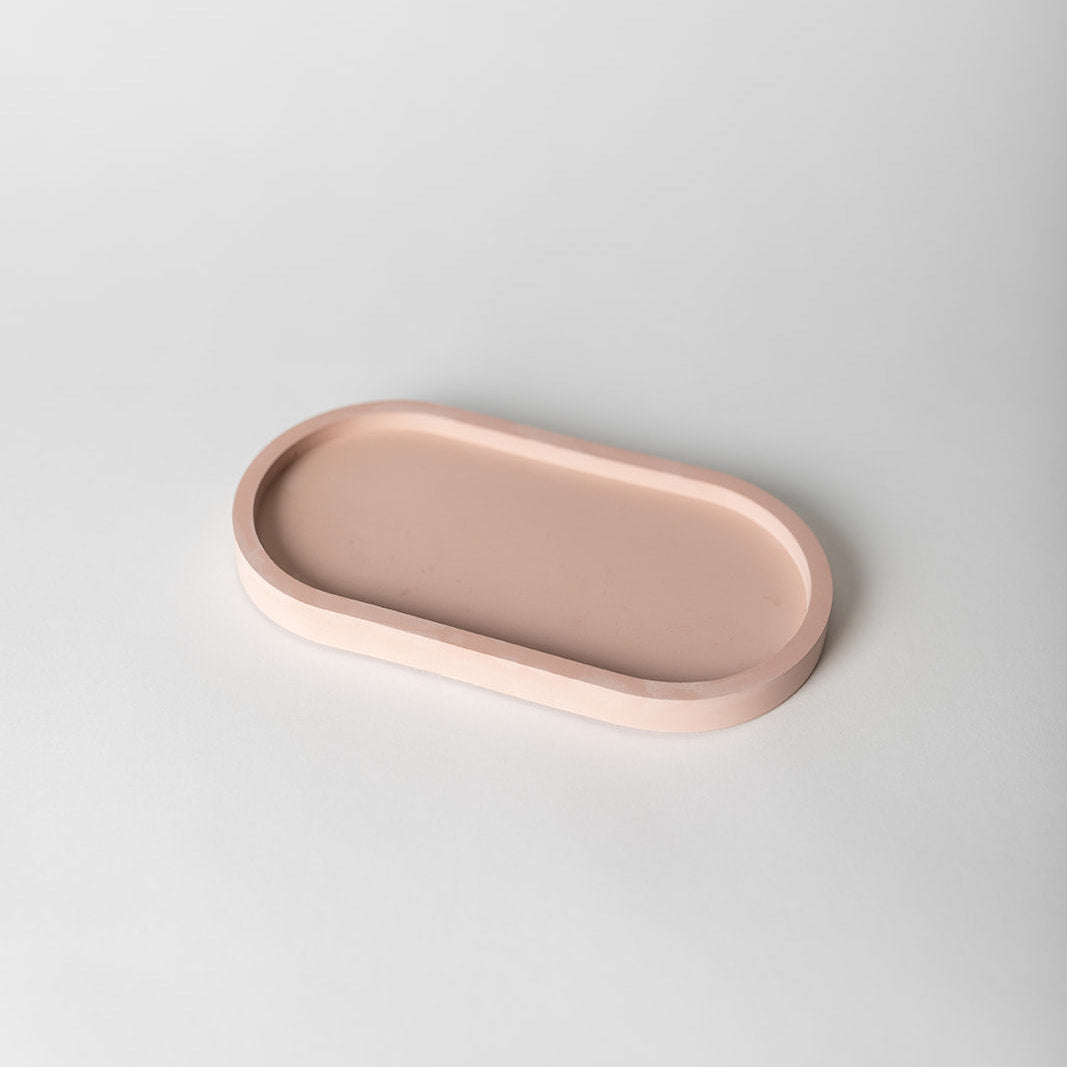 Pink pill shaped concrete candle tray.