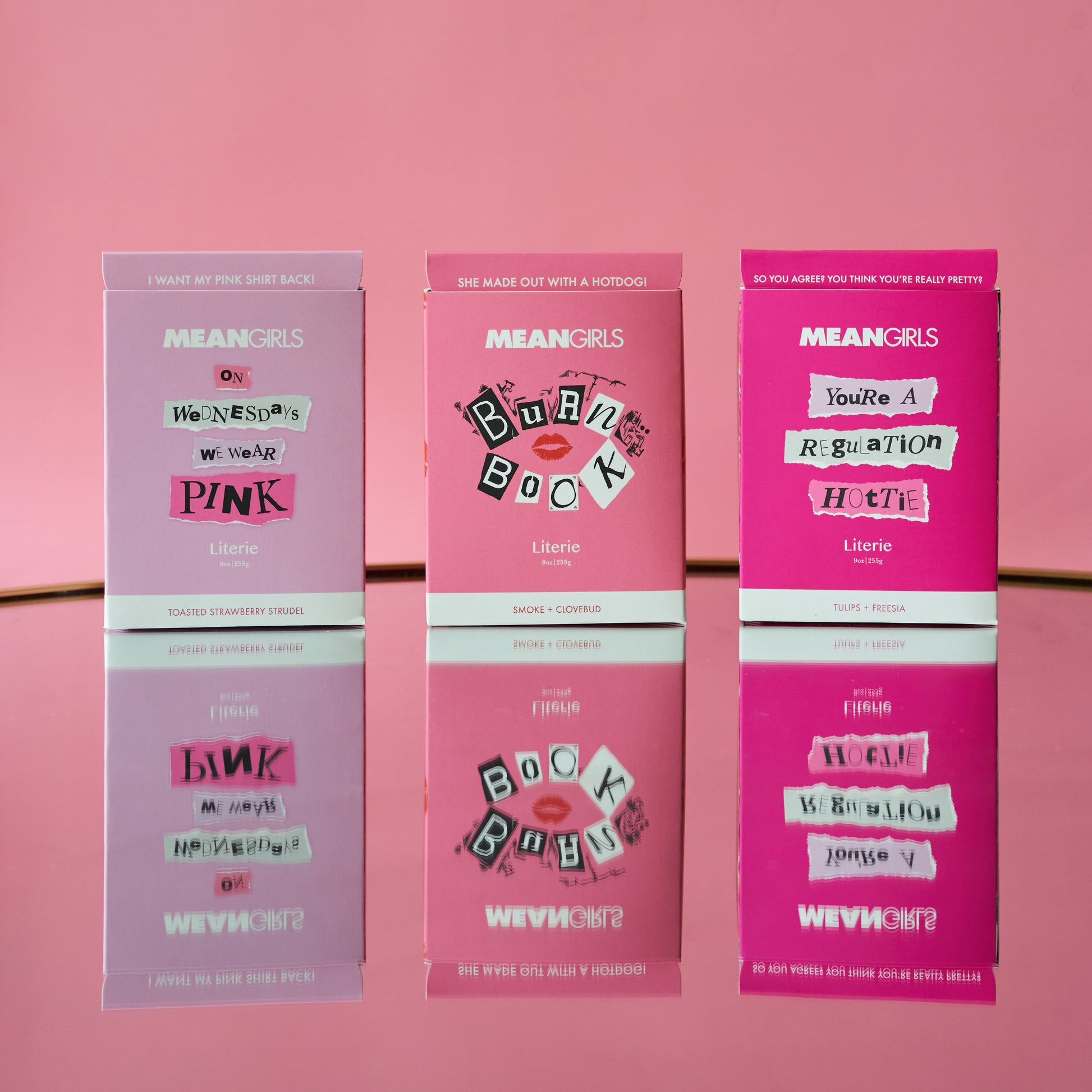 Three candle packages themed after the movie 'Mean Girls', with pink packaging and popular phrases from the film.