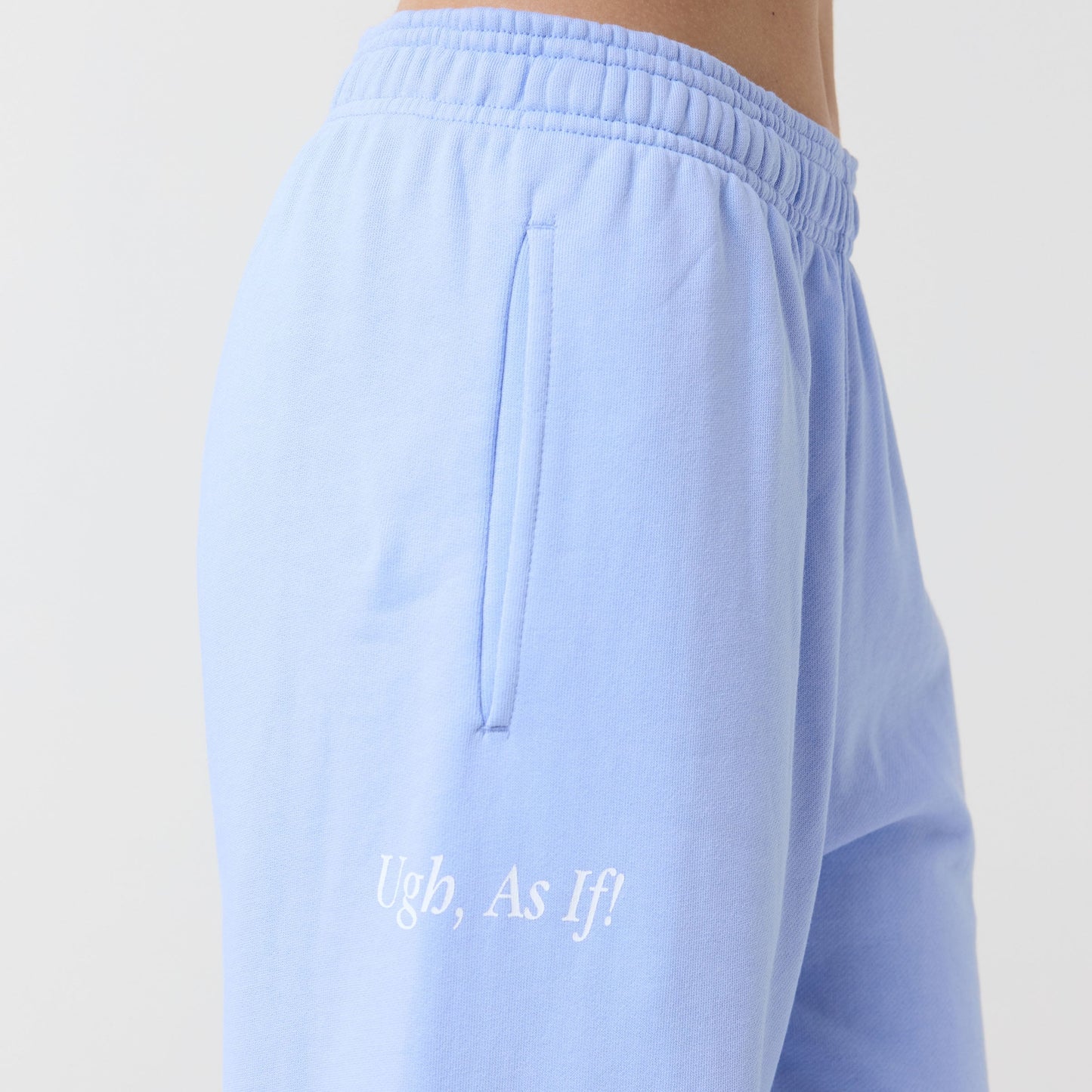 Light blue pants with text saying "Ugh, as if!" on a plain background