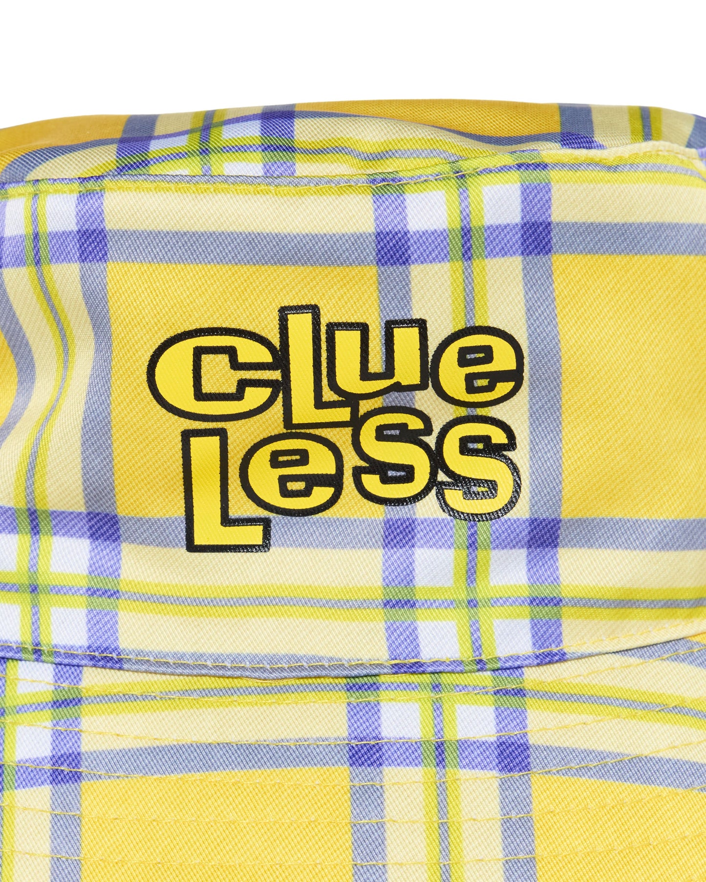 Yellow plaid fabric with 'Clueless' text in black