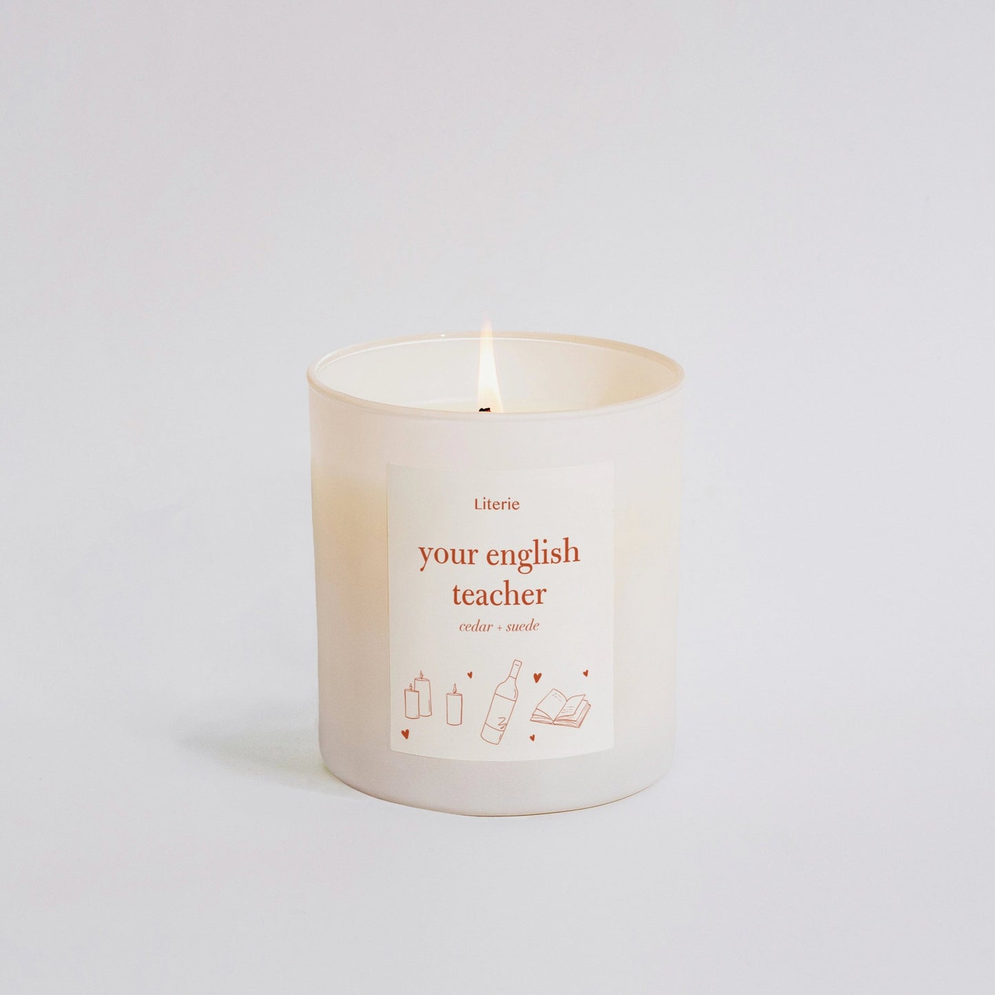 Candle that says your english teacher on it in orange.