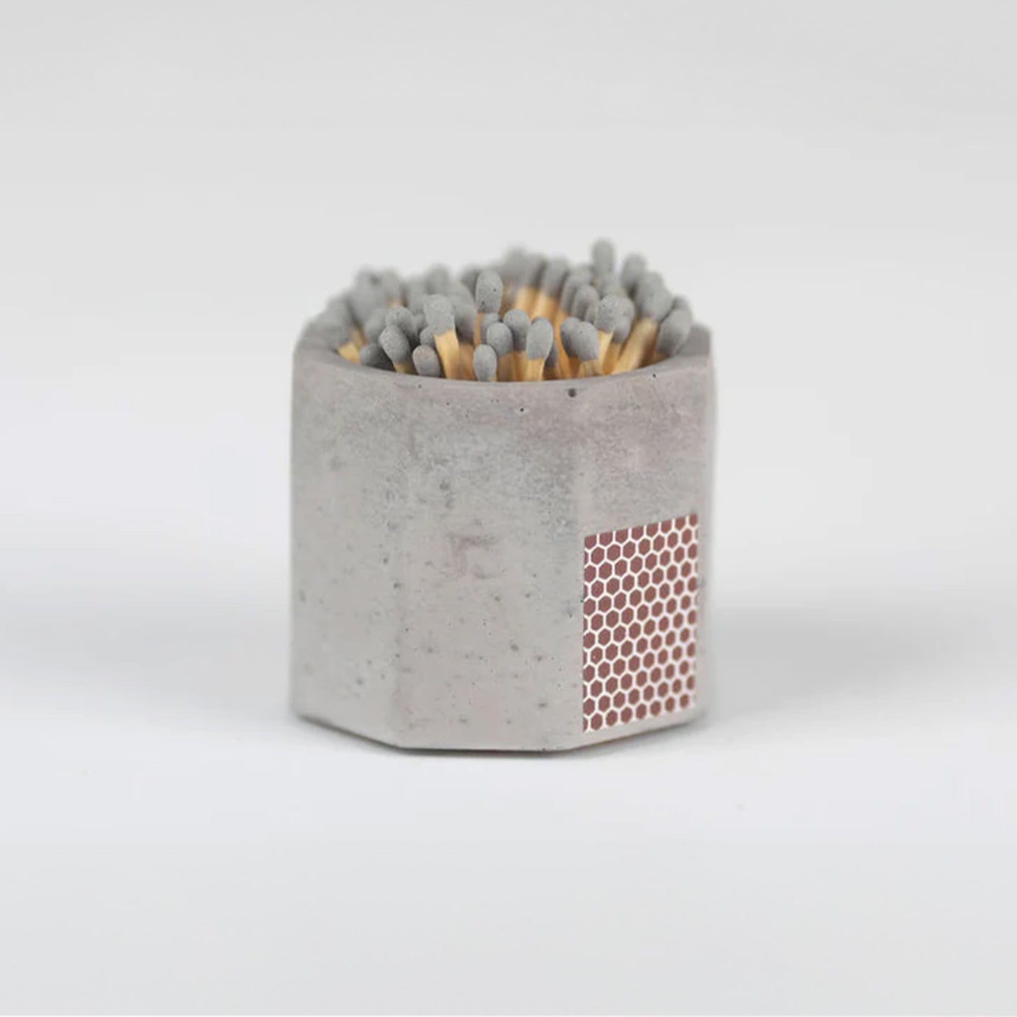 Grey concrete match stick holder with matches.