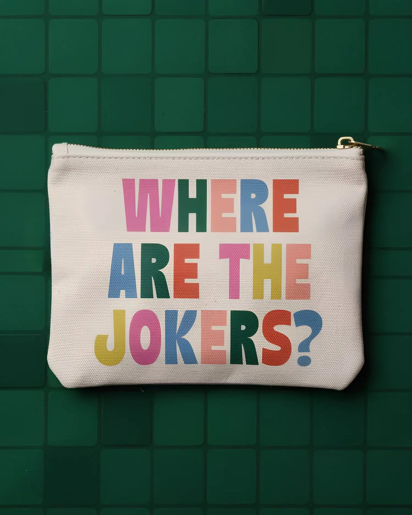 White pouch with colorful text 'WHERE ARE THE JOKERS?' on a green tiled background