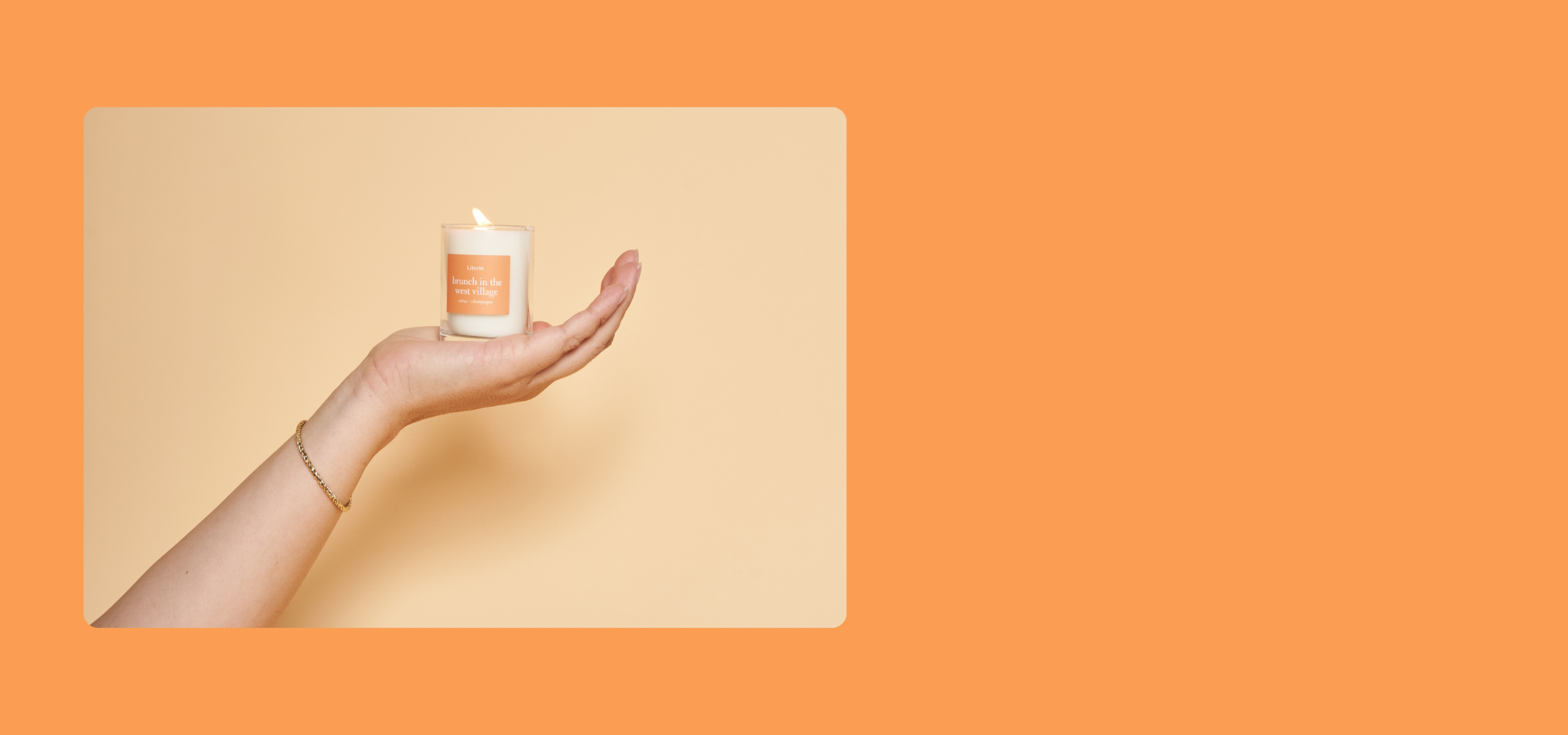 Hand holding a small white candle with a pattern against an orange background