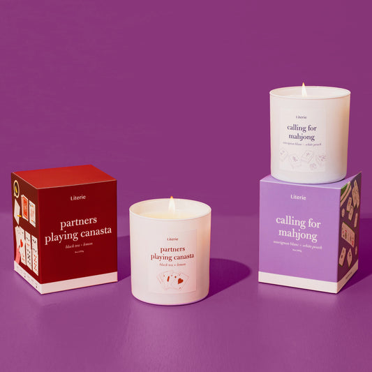partners playing canasta candle an calling for mahjong candle on a purple background.