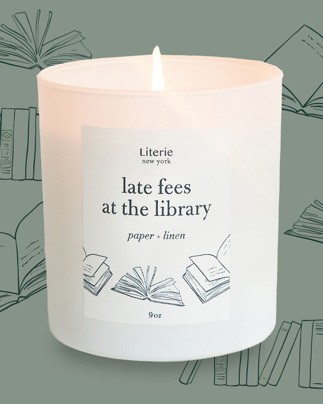 late fees at the library candle with illustration of books.