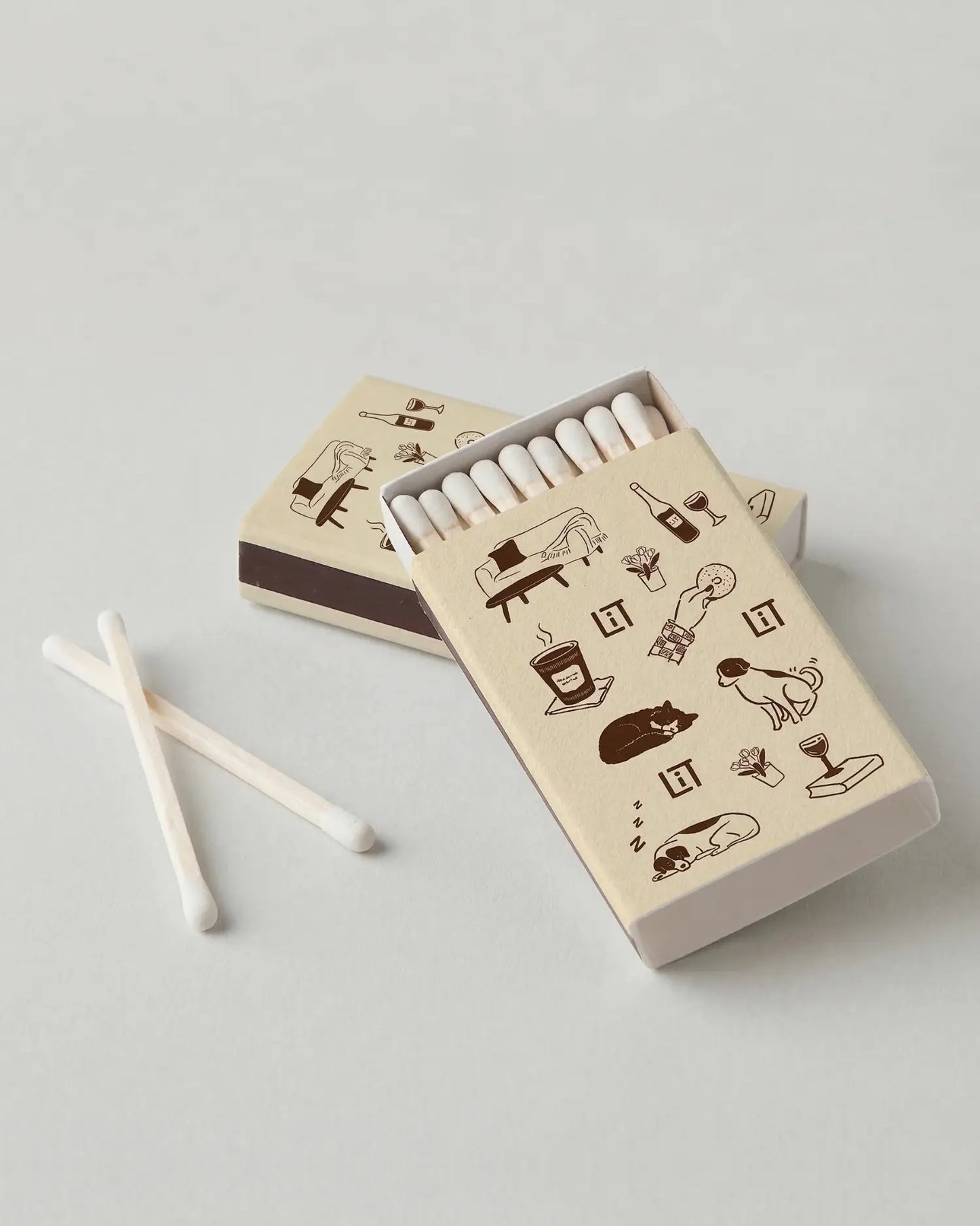 Three matchboxes with Literie illustrated designs on a light gray background