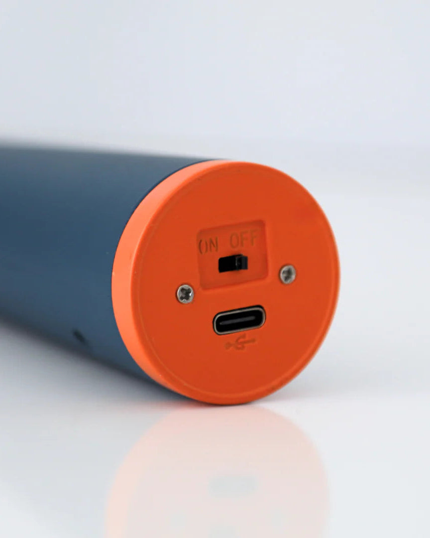 Lighter with orange charging bottom on a light gray background.