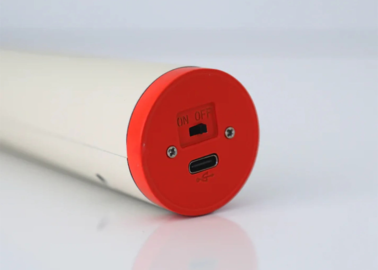 Bottom of the flume light in tan showing the charging port.