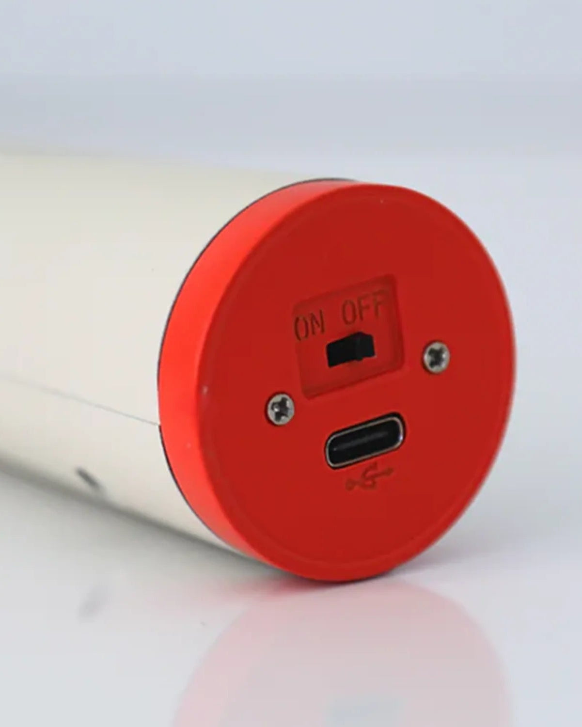 Bottom of the flume light in tan showing the charging port.