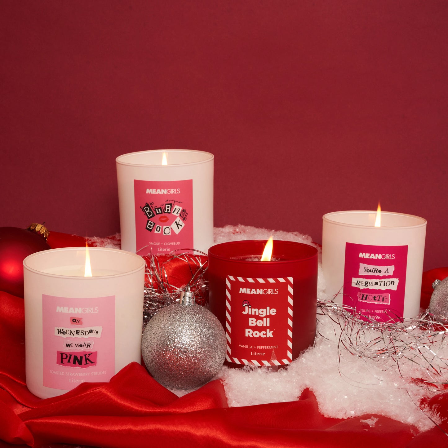 All four official candles of the Mean Girls movie next to ornaments.