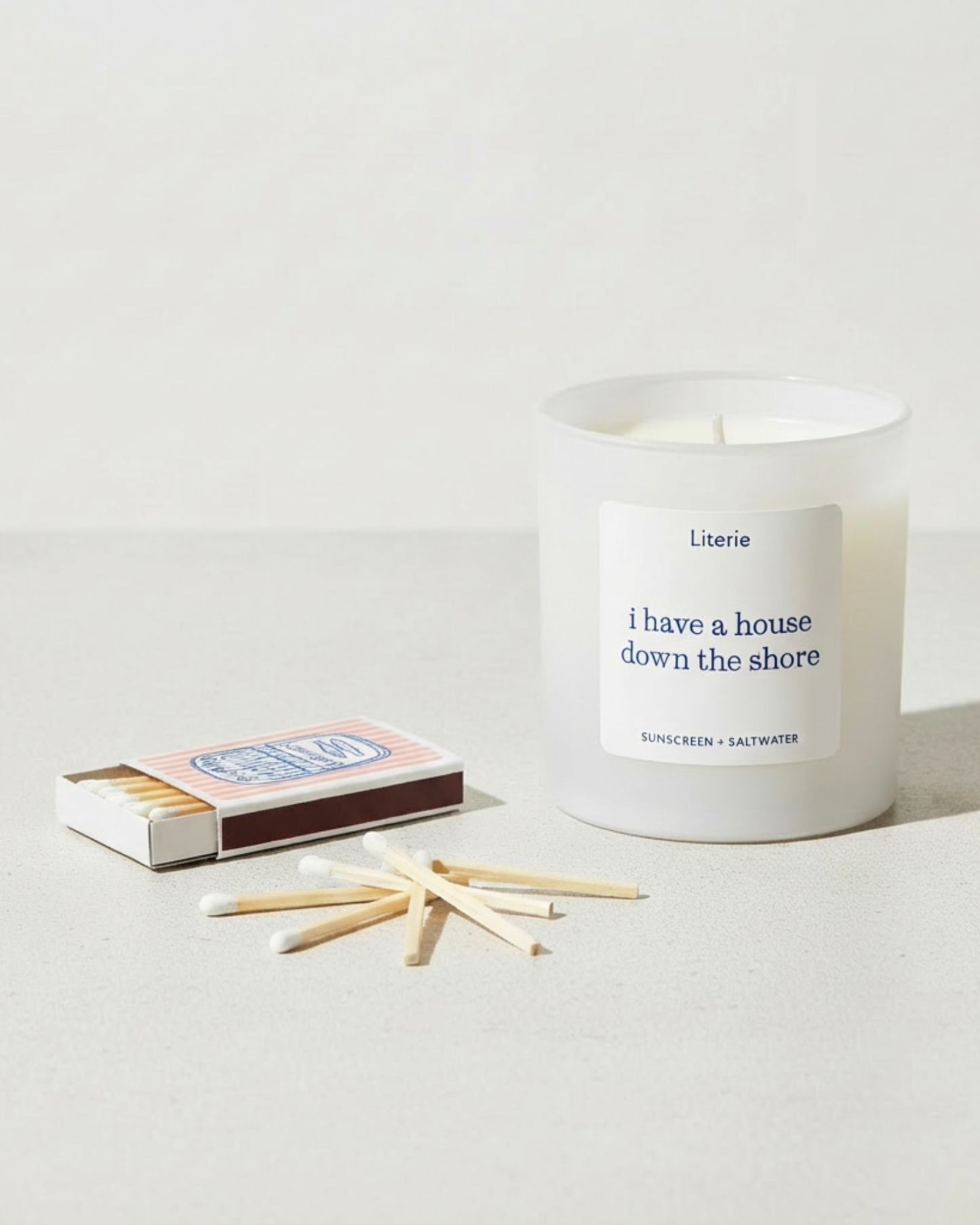 Candle with sardine matches on a light background