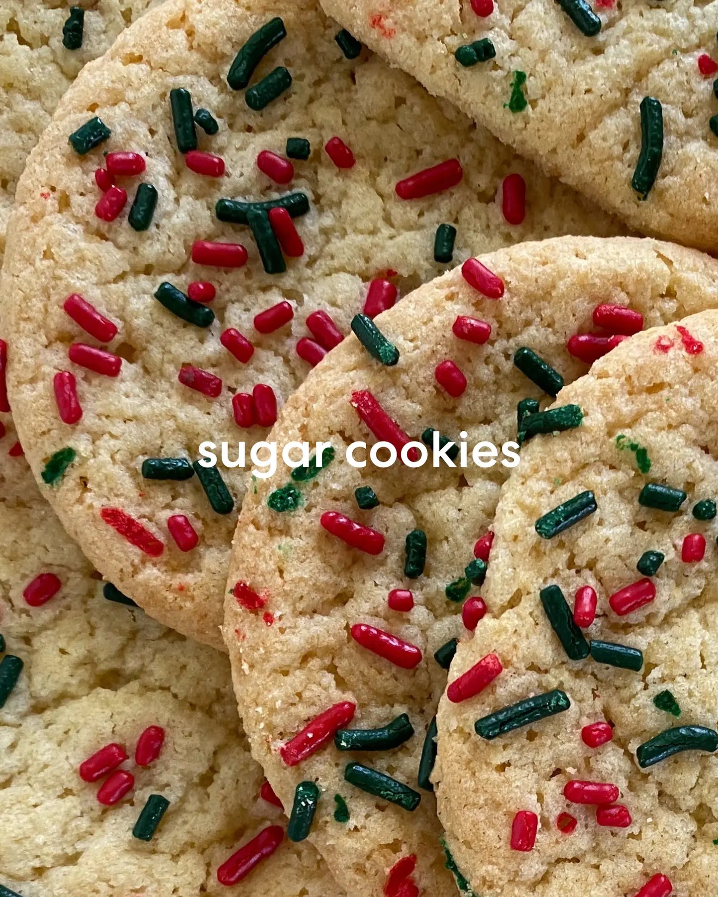 Pile of warm sugar cookies with green and red sprinkles.