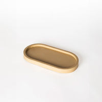 Taupe pill shaped candle tray.
