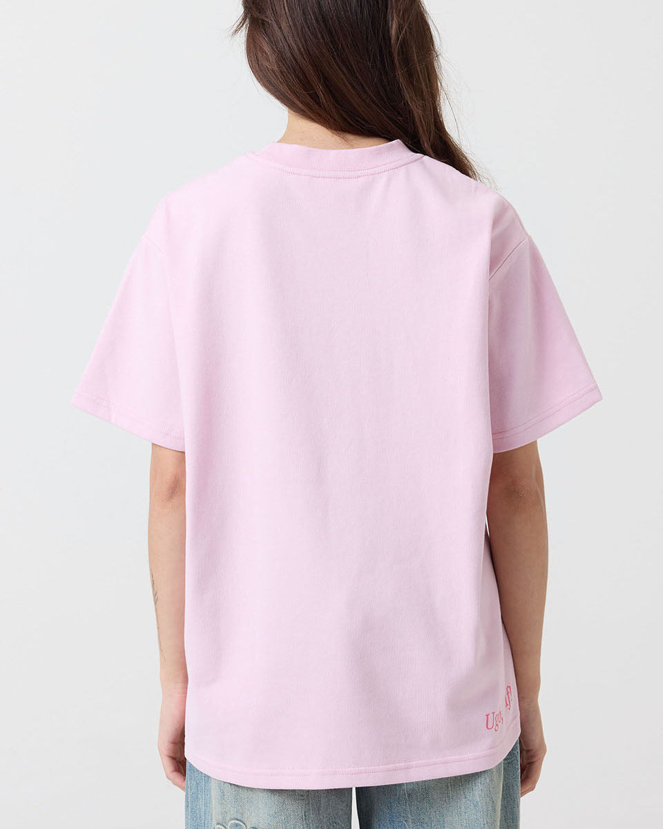 Person wearing a pink t-shirt with a brand logo on a white background
