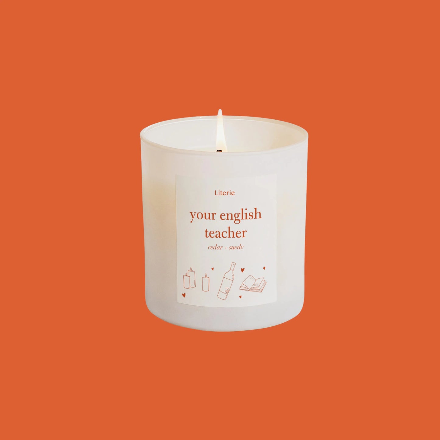 Candle that says your english teacher on it against an orange background.