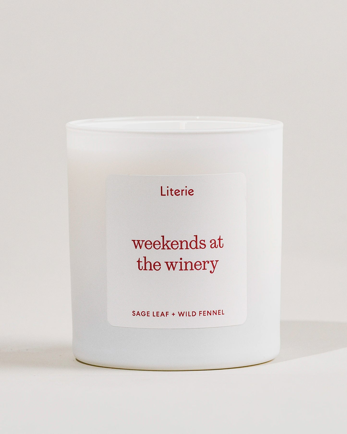 White Literie candle with a 'weekends at the winery' label on a light gray background