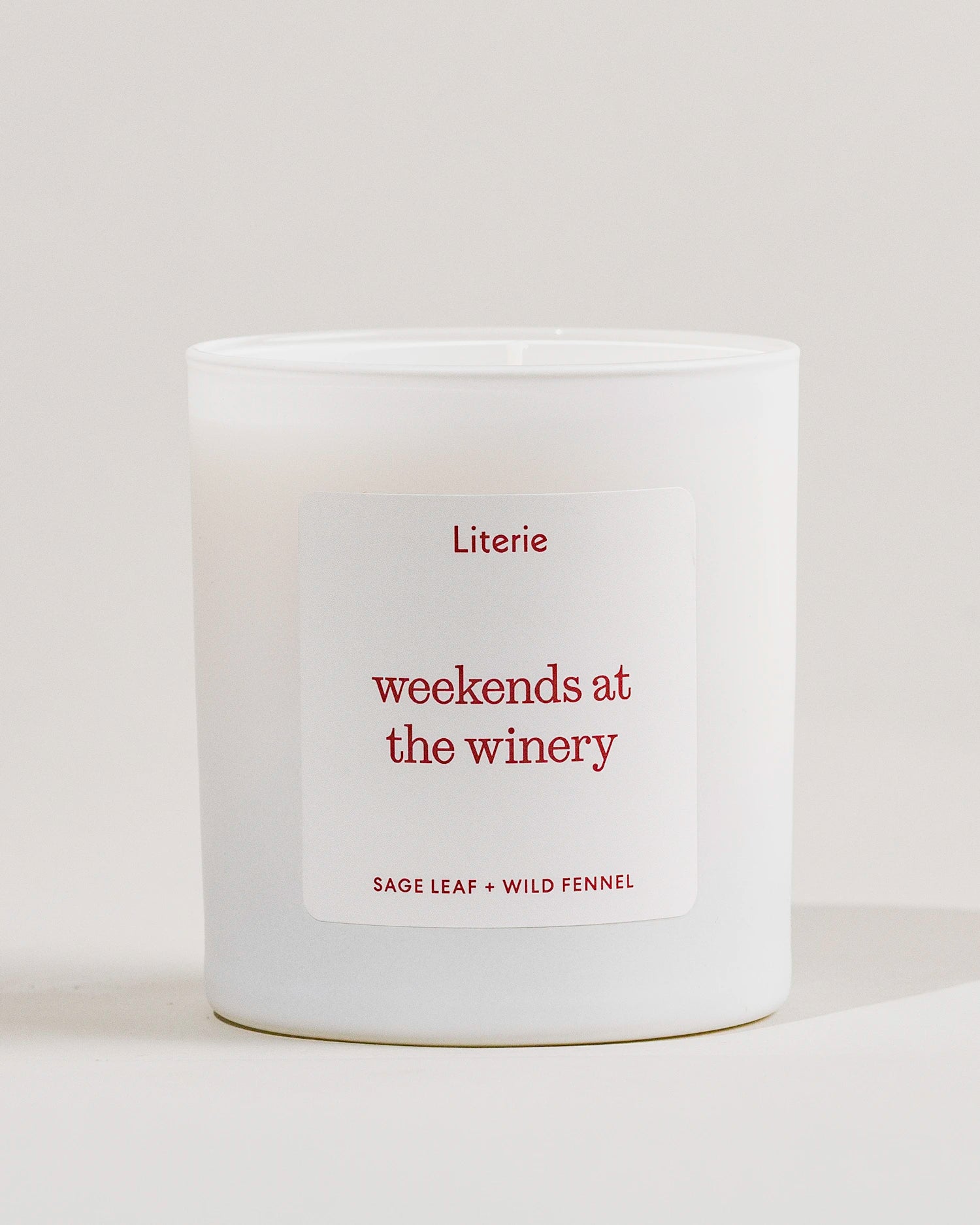 White Literie candle with a 'weekends at the winery' label on a light gray background