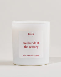White Literie candle with a 'weekends at the winery' label on a light gray background