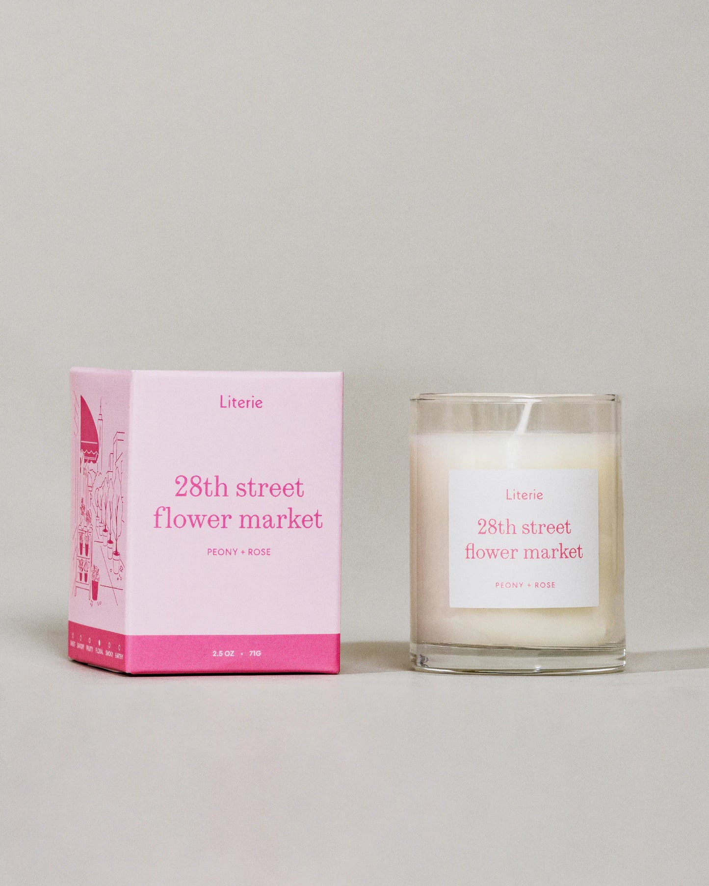 28th Street Flower Market (Little) candle by Literie next to packaging on a grey background.