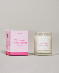 28th Street Flower Market (Little) candle by Literie next to packaging on a grey background.