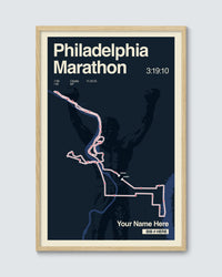 Framed poster of the Philadelphia Marathon route with a silhouette of a runner on a dark background.