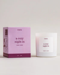 Literie candle and packaging with 'a cozy night in' text on a light background