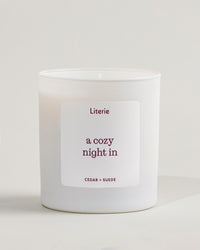 'a cozy night in' candle by Literie on a neutral background.