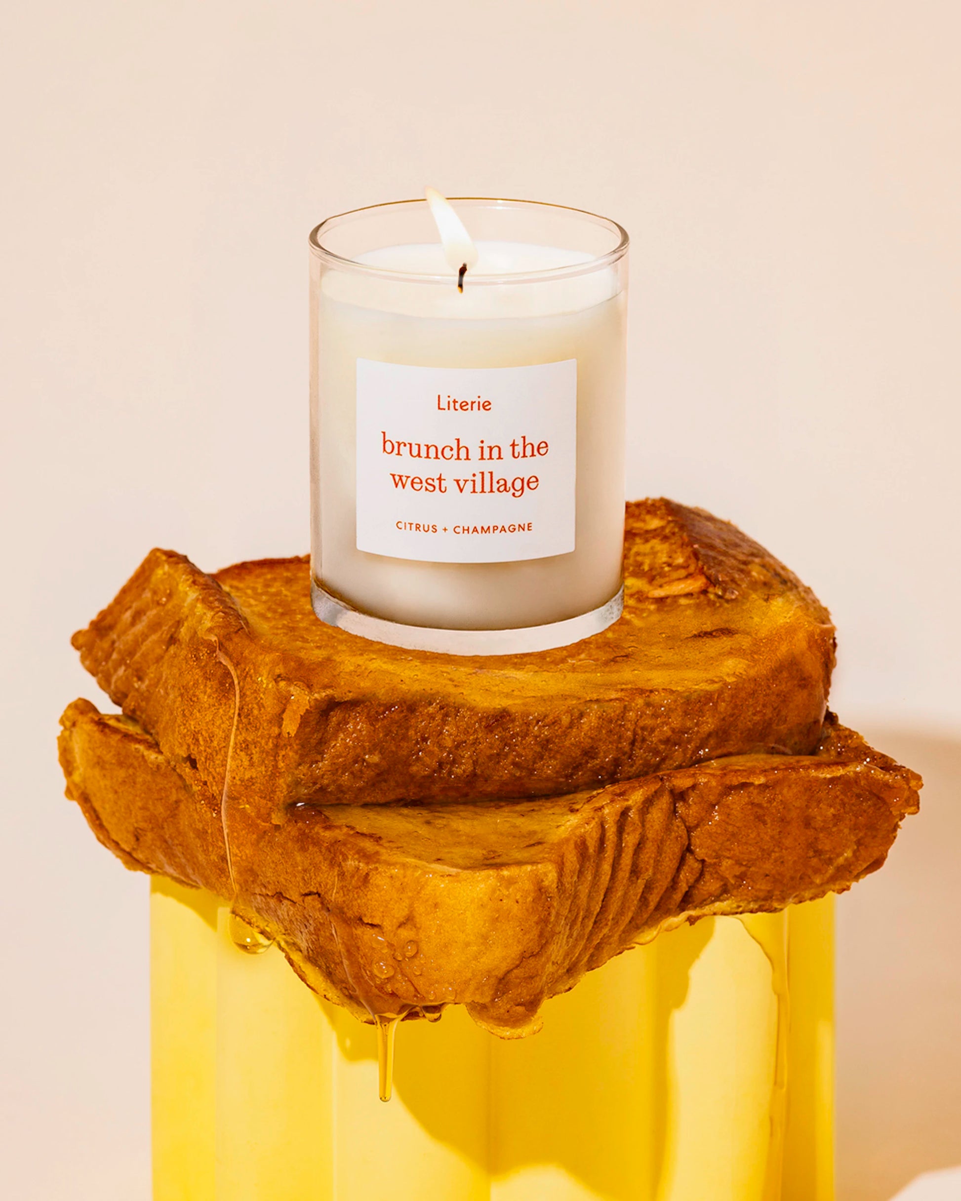 Literie's "brunch in the west village (little)" candle on top of french toast with syrup.