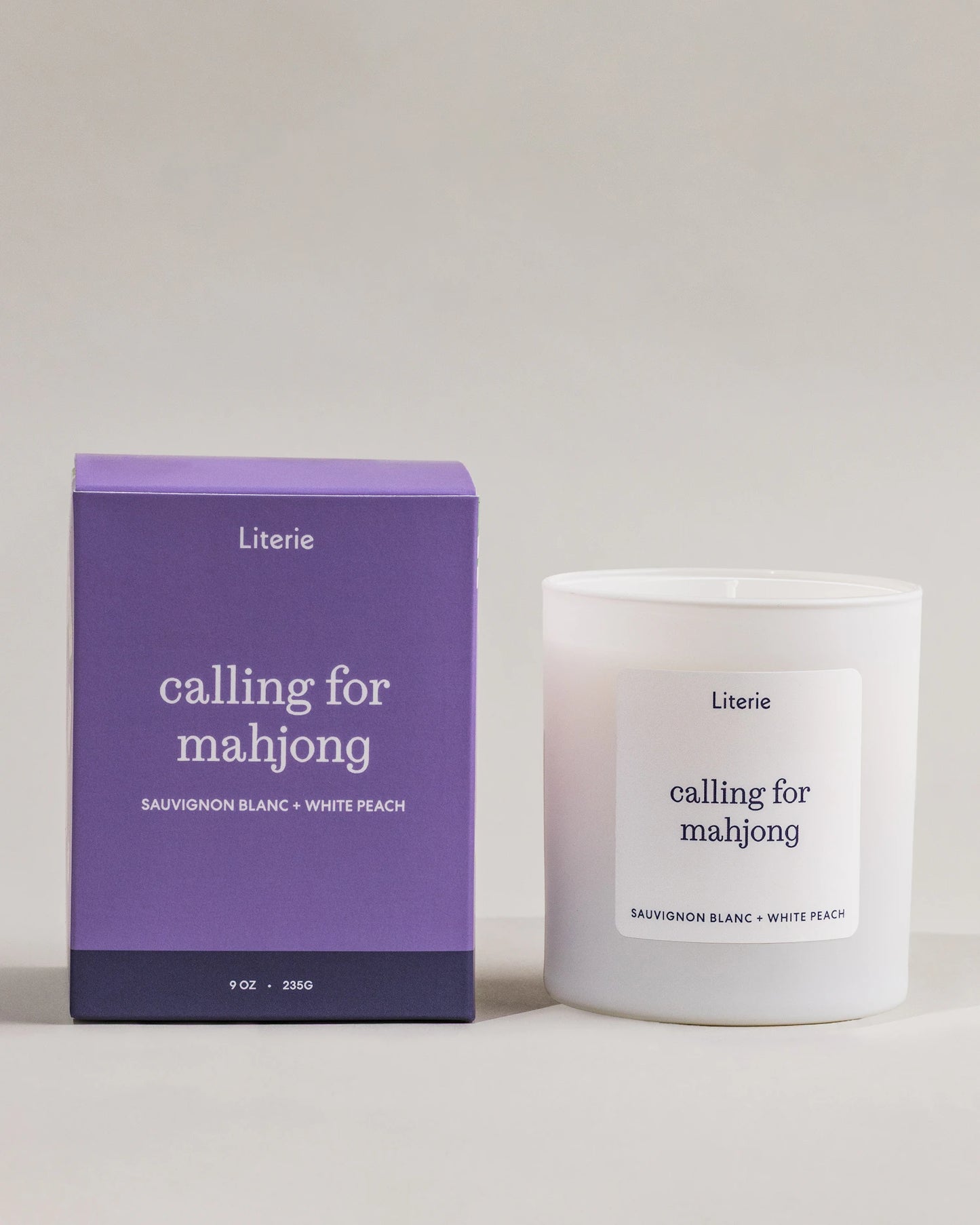 Literie candle and packaging labeled 'calling for mahjong' on a neutral background.