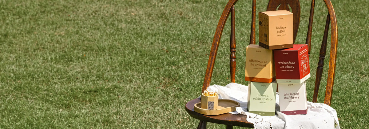 Fall candle boxes sitting on a wooden chair.