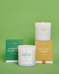 Weekends on the golf course candle and beers at the ballpark candle with boxes.