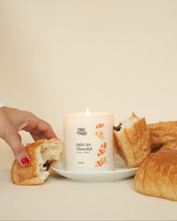 Pain au chocolat Emily in Paris candle with dessert.