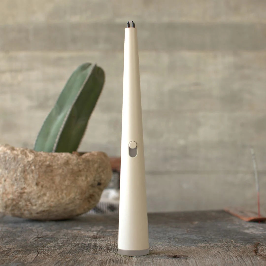 Luma Flume electric lighter on wood table with cactus in background.