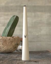 Luma Flume electric lighter on wood table with cactus in background.