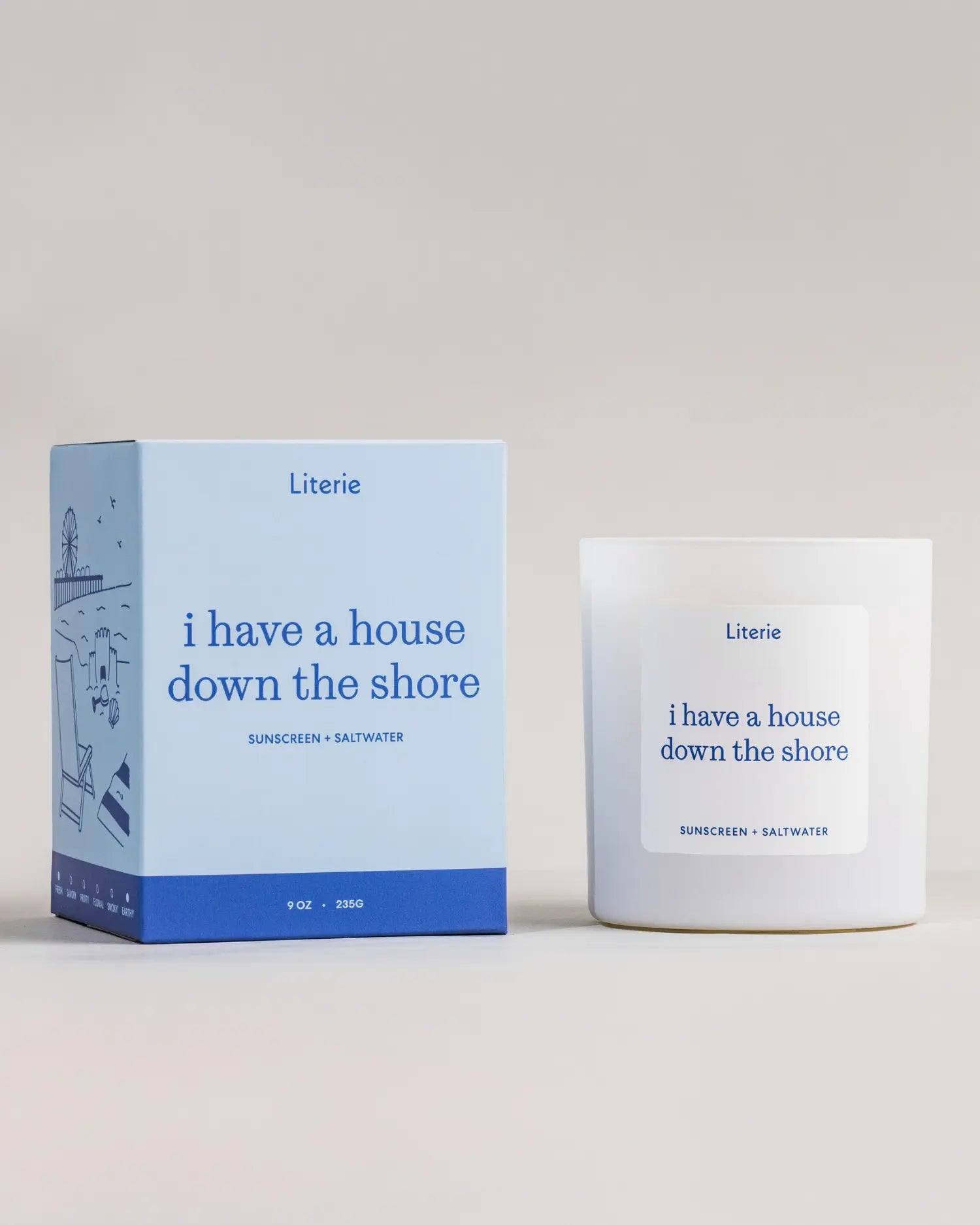 Literie ‘I have a house down the shore’ candle and packaging with blue and white design on a light gray background