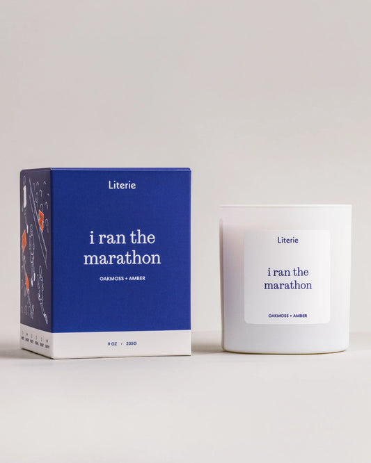 Literie candle packaging with 'i ran the marathon' text on a white background