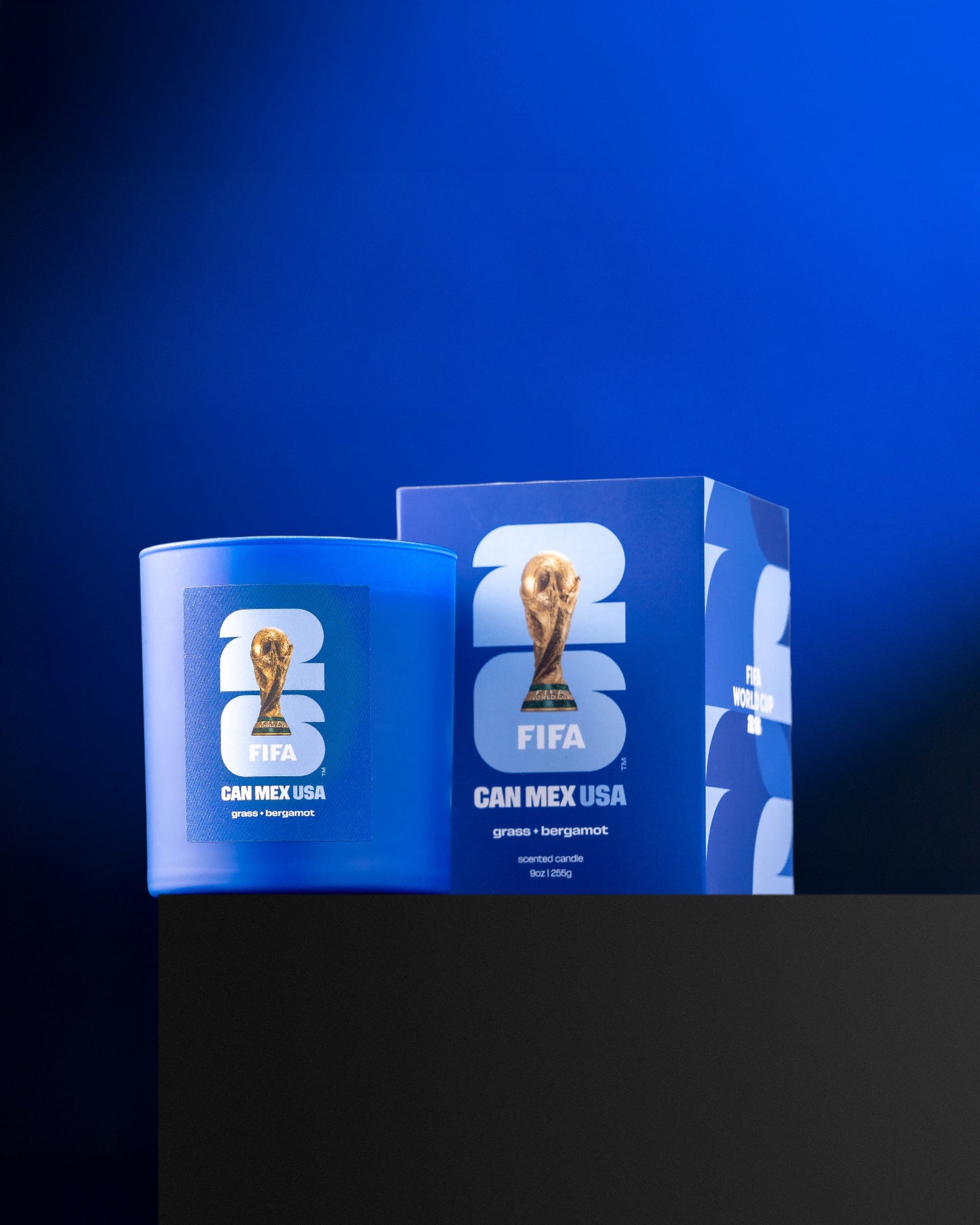 Blue candle and box with FIFA World Cup trophy design on a blue background