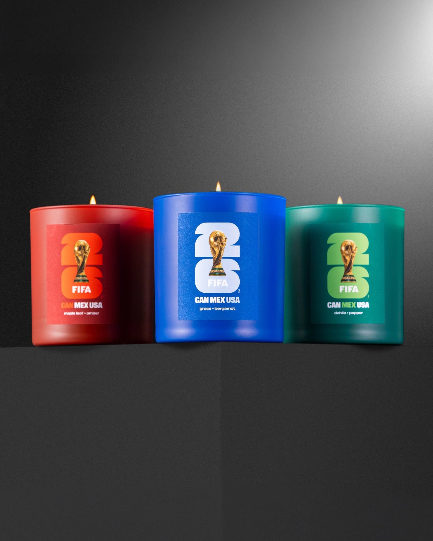 Three 2026 FIFA World Cup -themed candles on a dark background made by Literie.