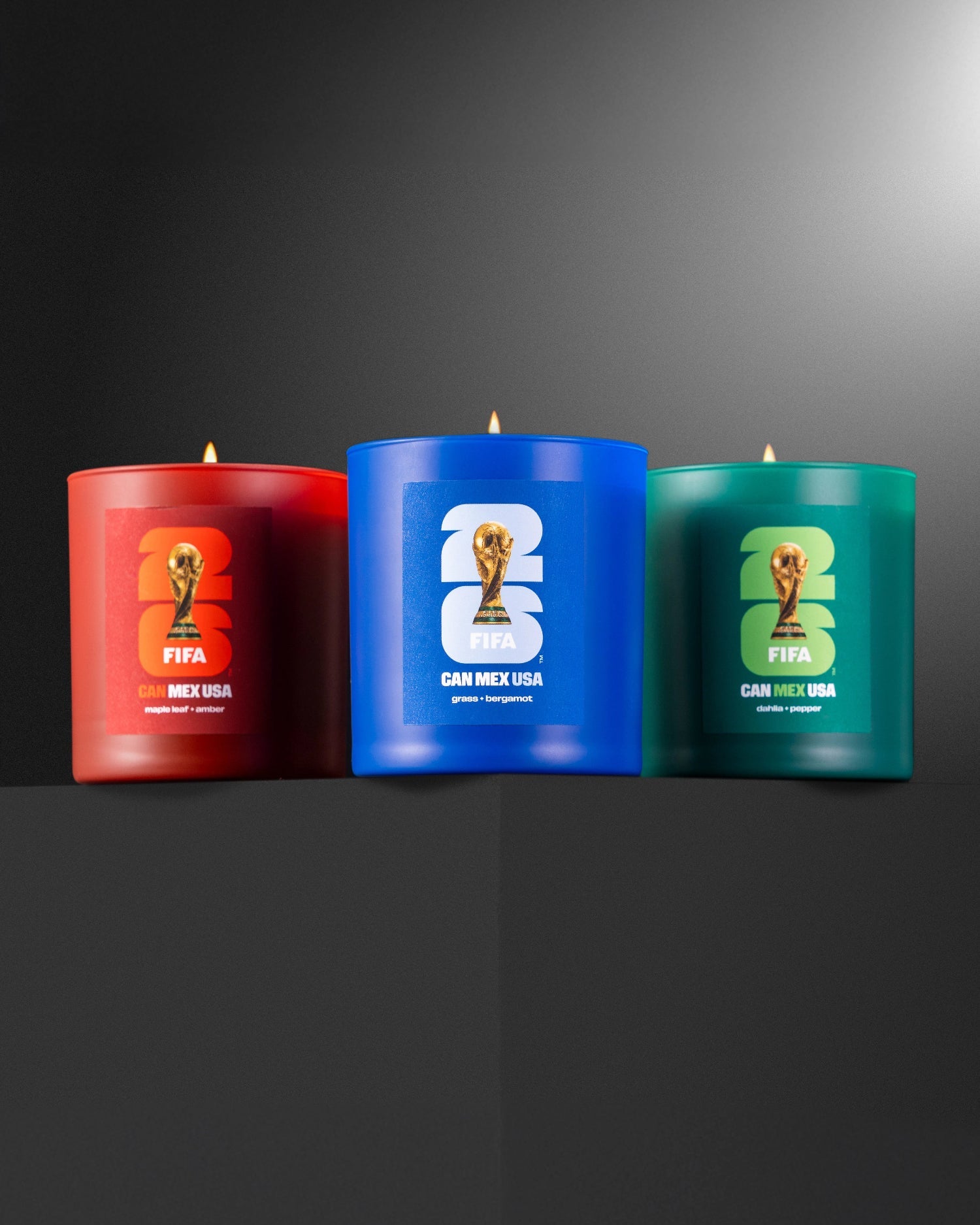 Three 2026 FIFA World Cup -themed candles on a dark background made by Literie.