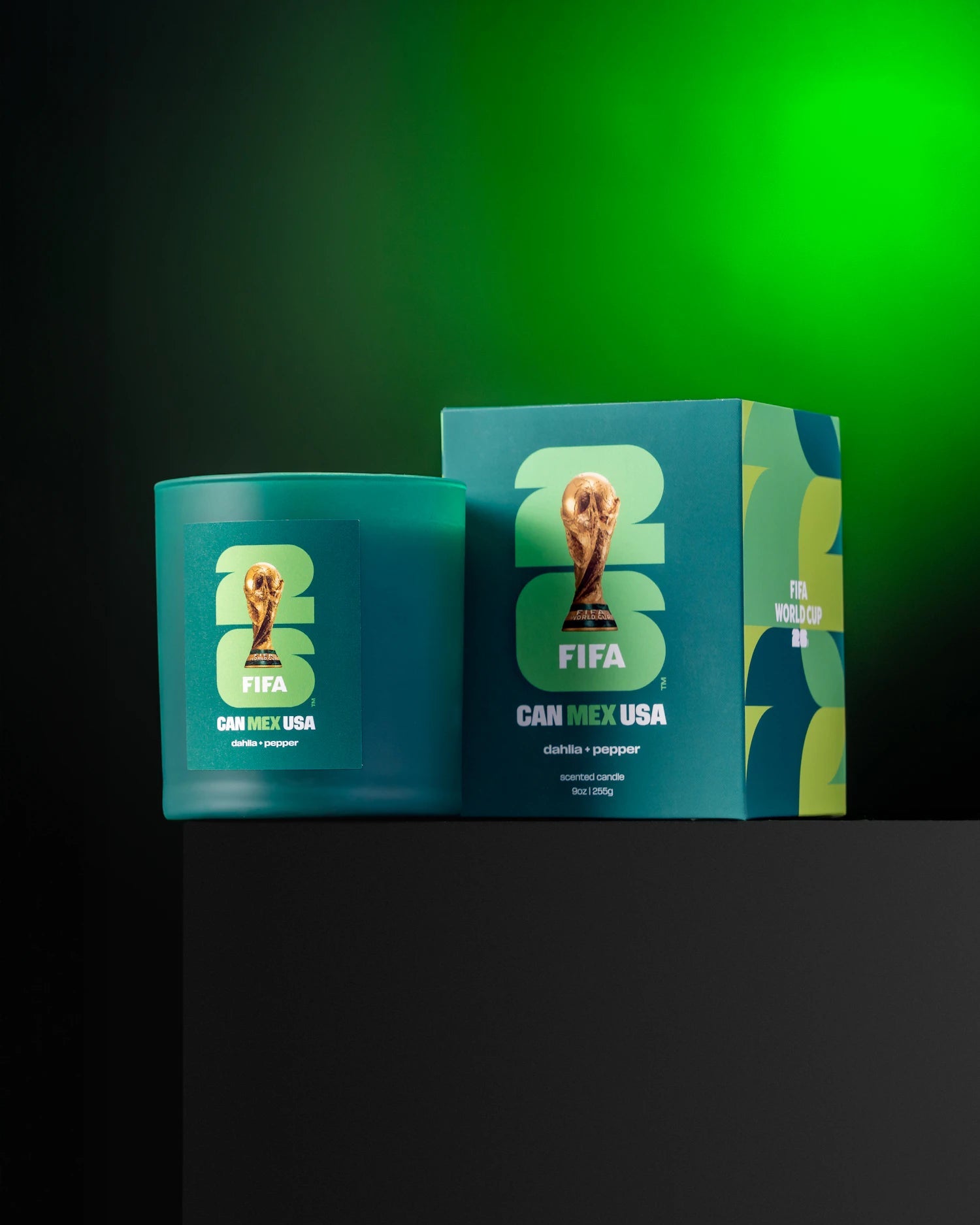 Green candle and box with FIFA 2026 World Cup branding on a green background.