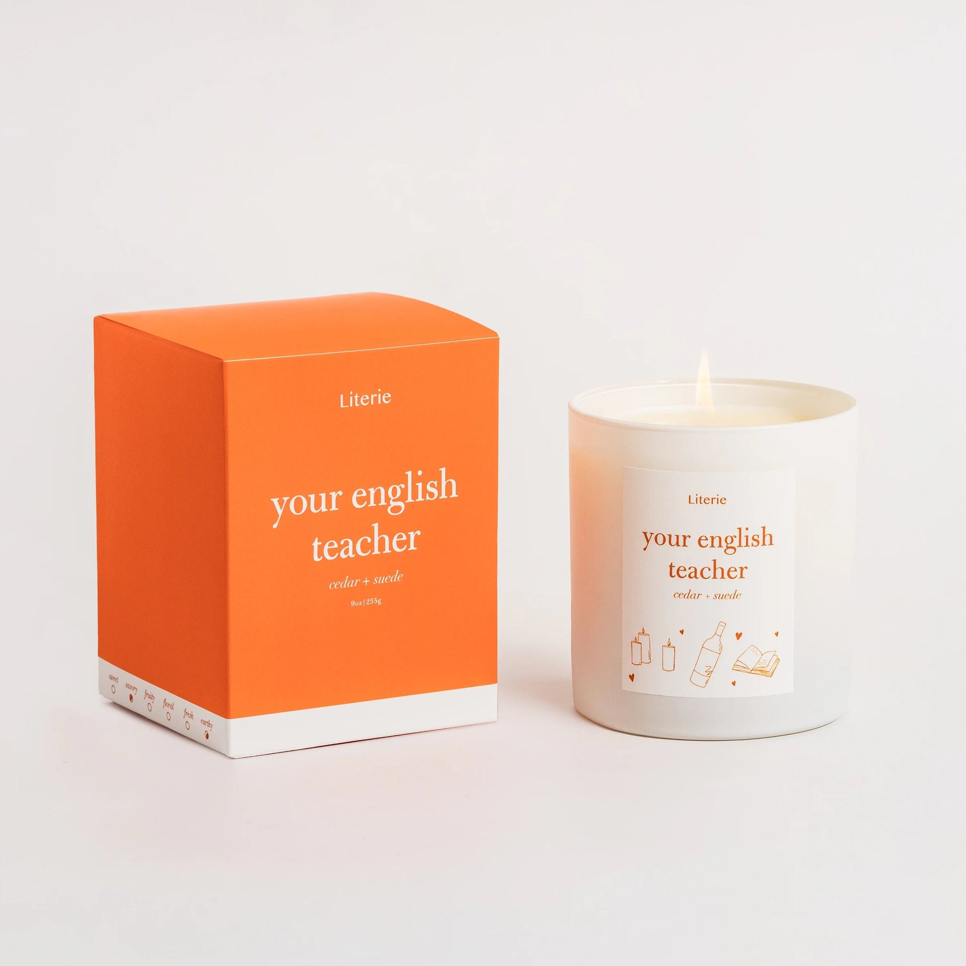Candle and packaging with 'your English teacher' text on a white background