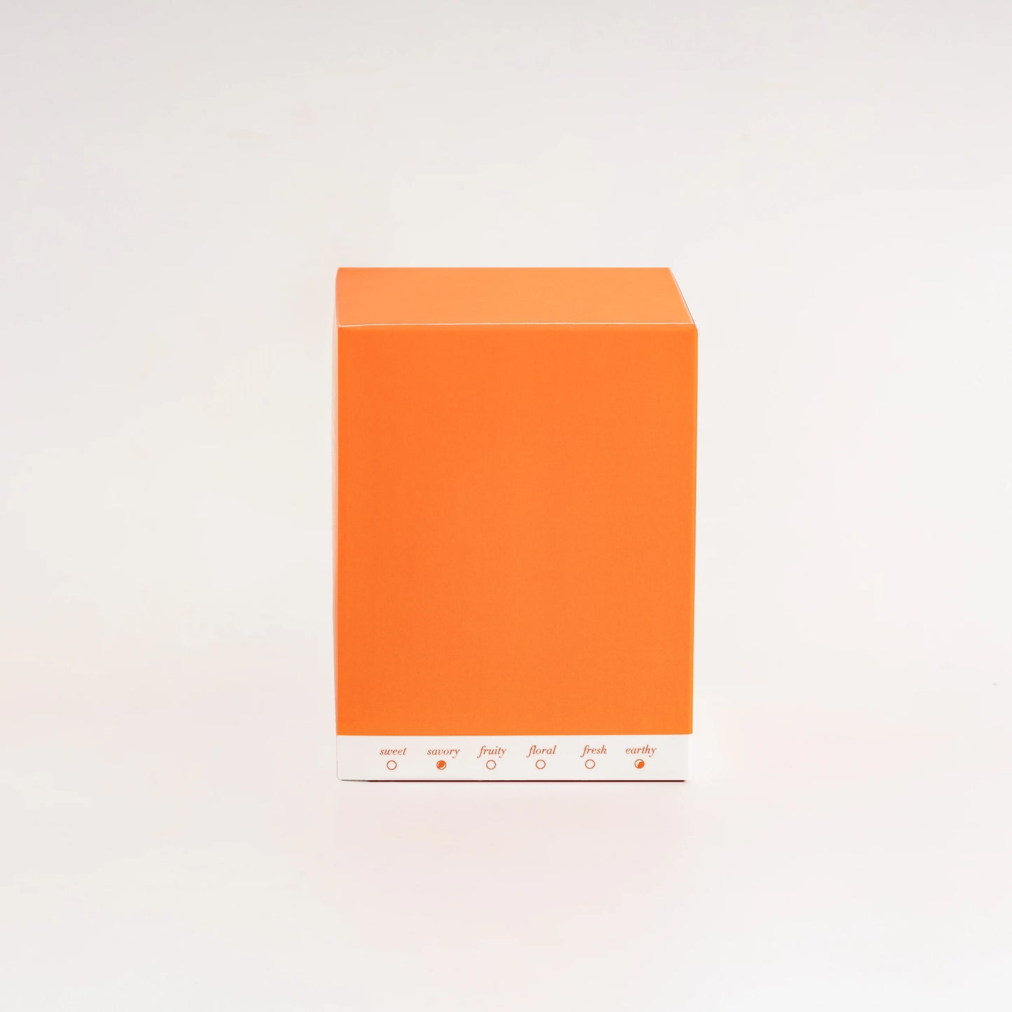 Orange box with scent swatches on a light gray background