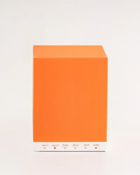 Orange box with scent swatches on a light gray background