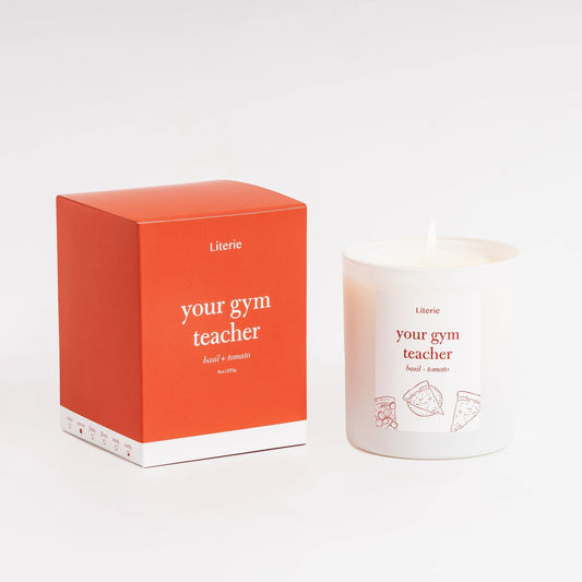 Candle and packaging with 'your gym teacher' text on a white background